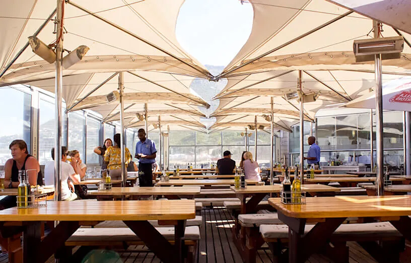 A full deck of guests under the canopies on a sunny afternoon