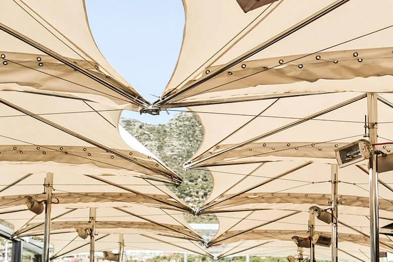 White sail-cloth canopies stretched over the deck